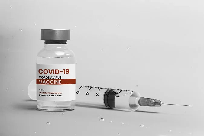 Janssen COVID-19 vaccine bottle and side syringe